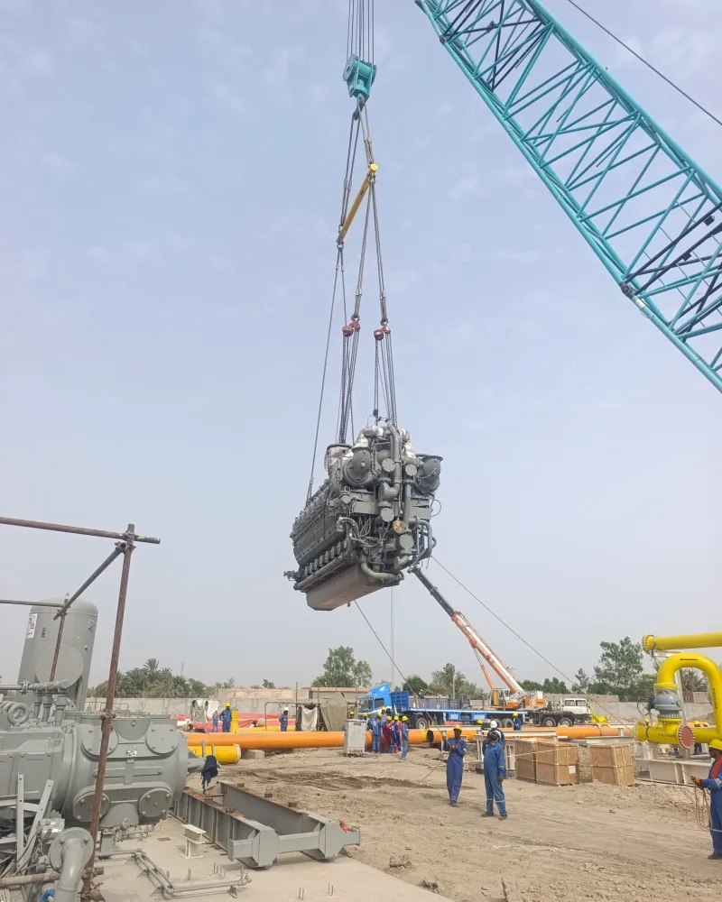 Gas engine lifted by crawler crane onto a compressor package